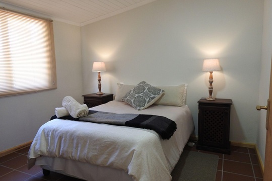 Spacious main bedroom with double bed and packing space at The Bush Buck Cottage