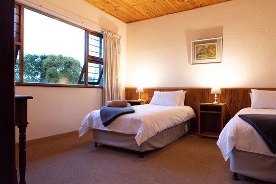 Two single beds in a spacious bedroom at Natures Way Farmhouse