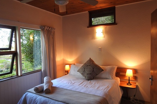 A lot of natural lighting with double bed at Natures Way Farm Cottage
