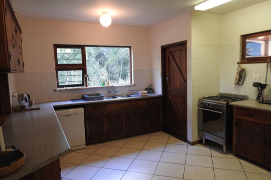 Fully equipped self-catering kitchen with gas kettle, stovetop, oven, toaster, microwave, bar fridge at Natures Way Farmhouse
