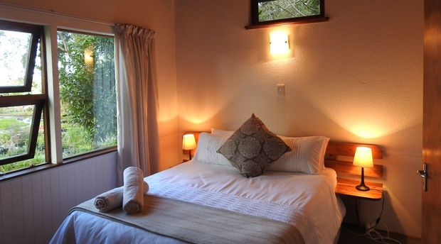 A lot of natural lighting with double bed at Natures Way Farm Cottage