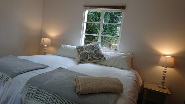 Comfortable Bush Pig Cottage main bedroom with en suite and good natural lighting